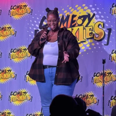 IMG_2532 Comedian Asia Chardonnay performing at Comedy Junkies stand-up.